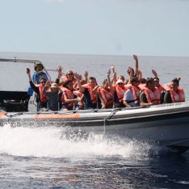 a group of people on a boat in the water