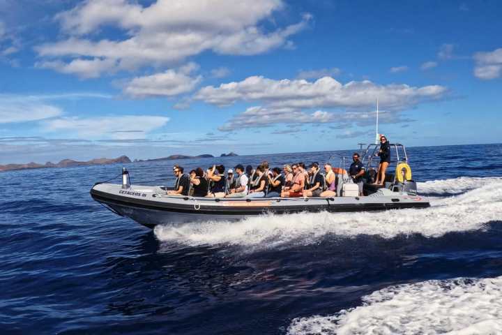 a group of people in a boat on a body of water