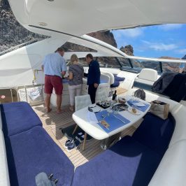 a group of people standing around a table