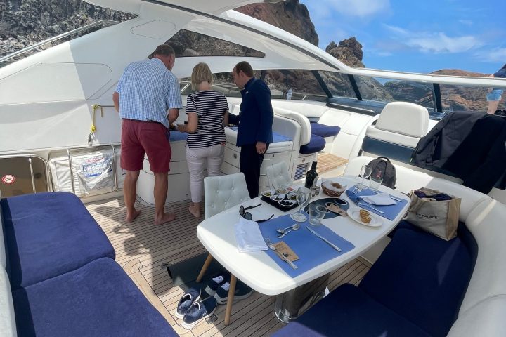 a group of people standing around a table