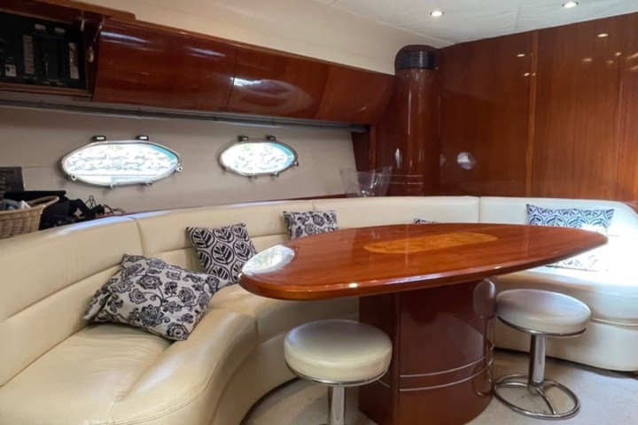 a room with a couch a table and chairs