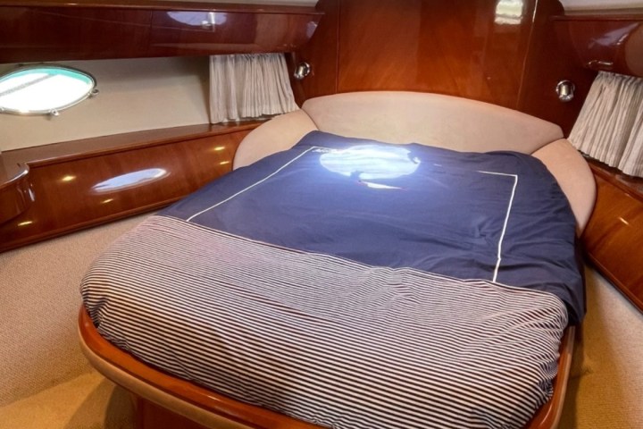 a pile of luggage sitting on top of a bed